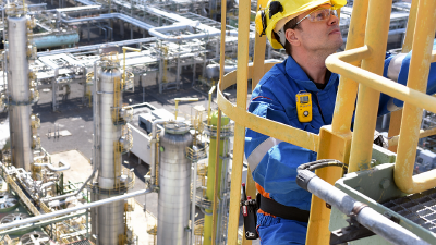 Worker in safety gear on refinery platform