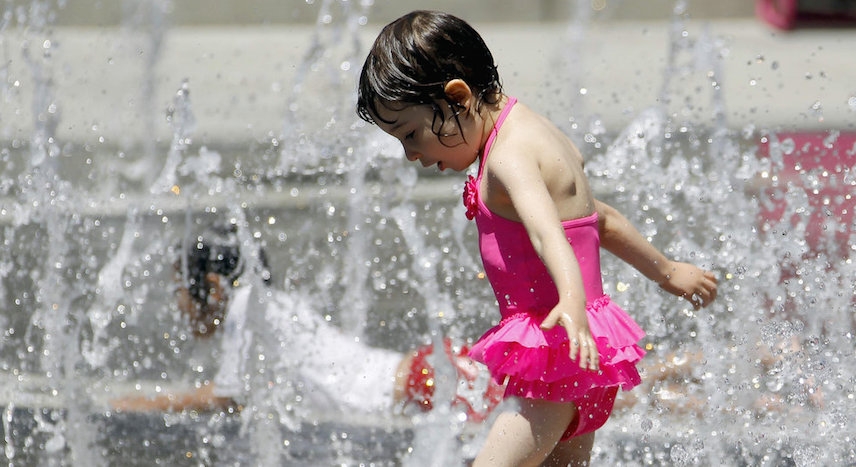 Child playing water in hot weather