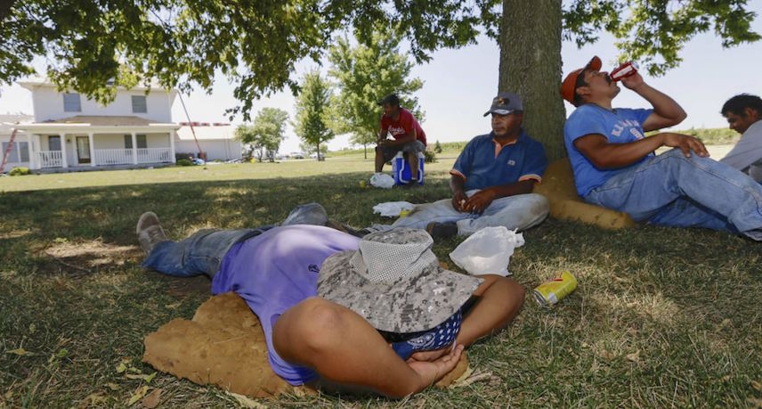 Workers enduring the heat during their break at the worksite