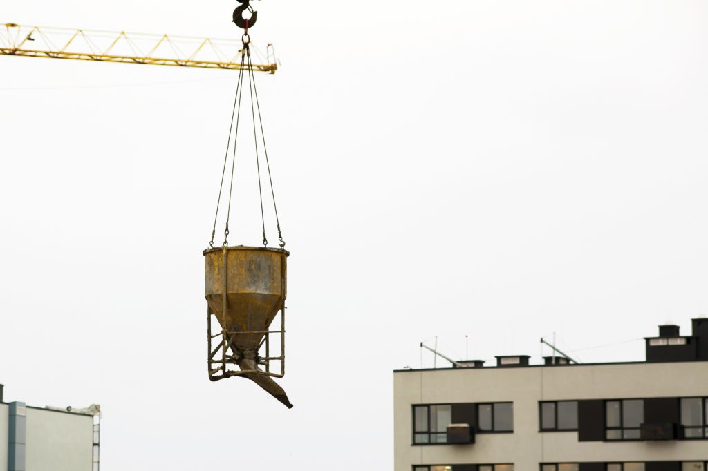 At New Skyscraper Construction Site, Crane Lifting Cement Bucket